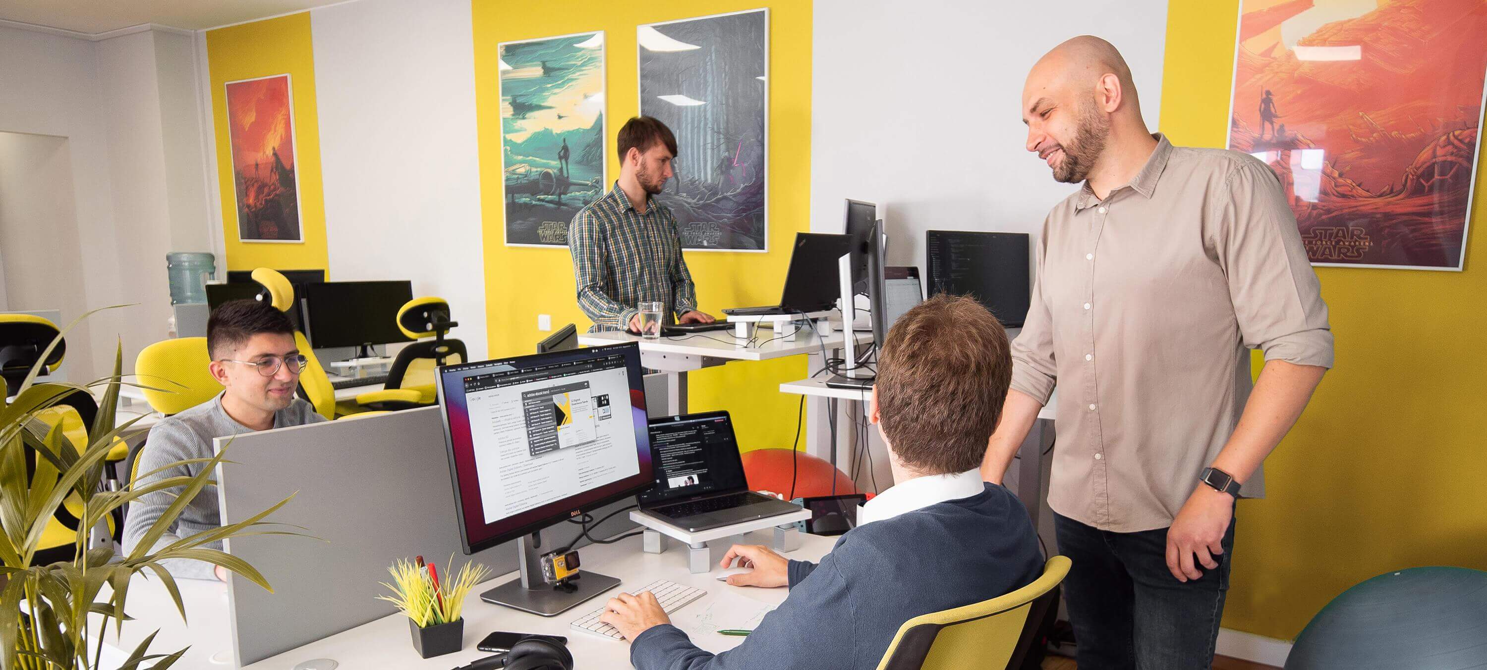 Photo of a team working and talking about the website project